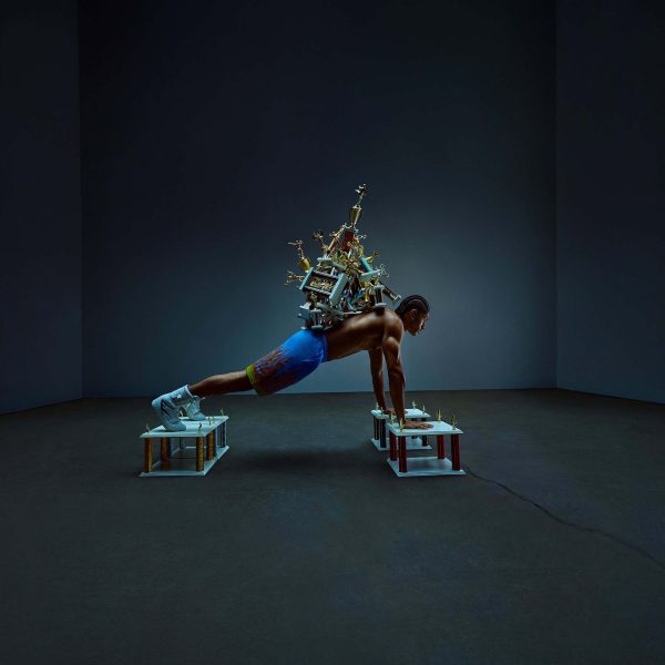 essentia-pushup Athlete doing pushup with trophies on back
