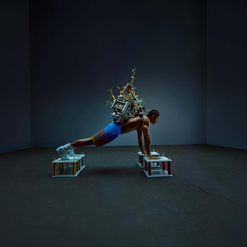 essentia-pushup Athlete doing pushup with trophies on back